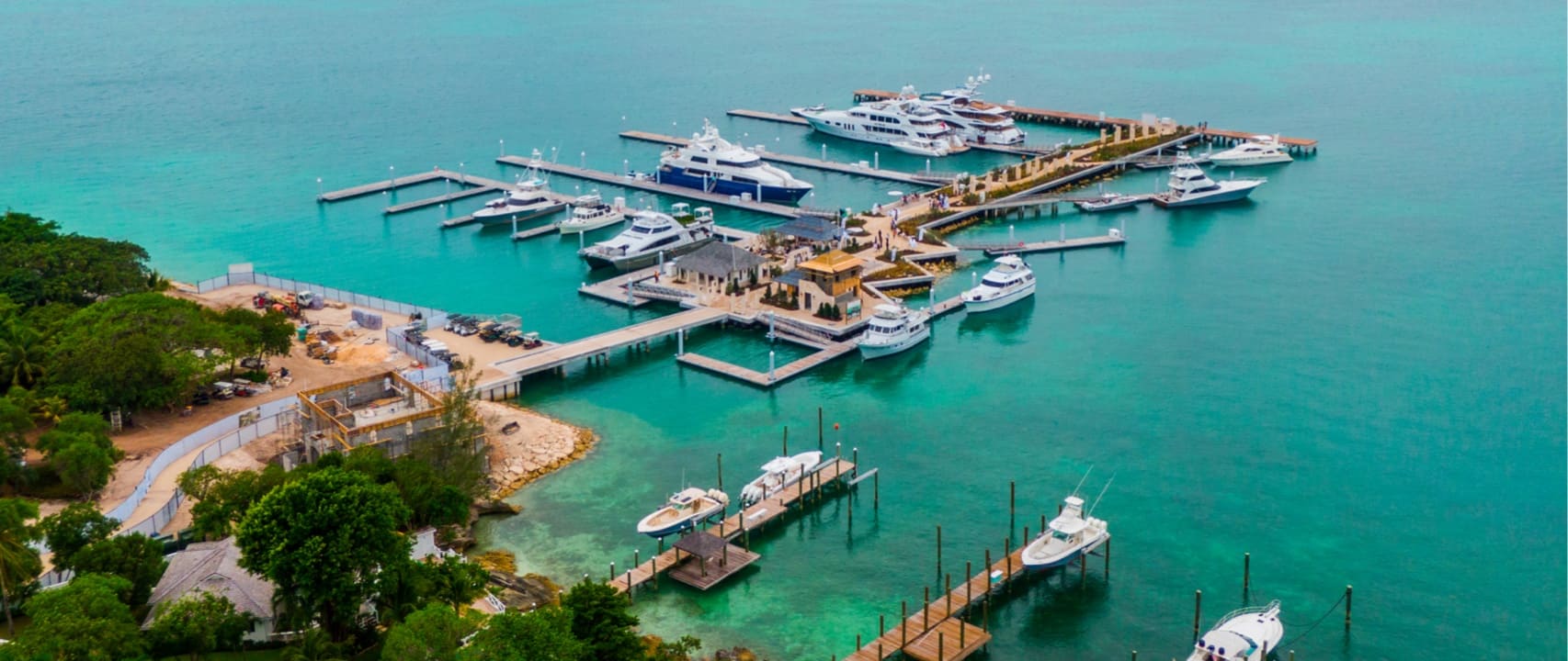 Aluminum marina with large yachts moored in turquoise sea in the Bahamas